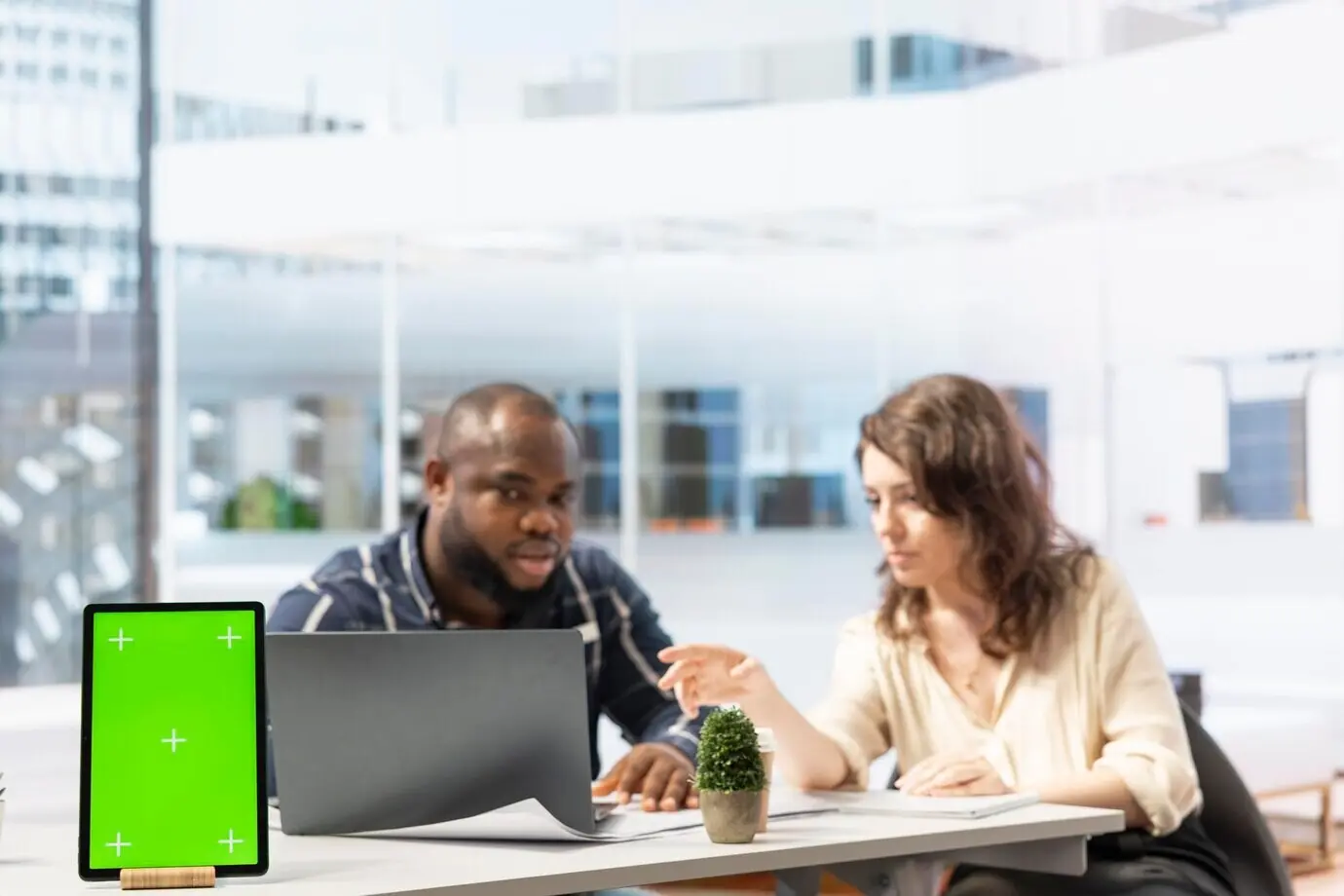 Предприниматель вместе с агентом по недвижимости изучает чертежи рядом с изолированным экраном.